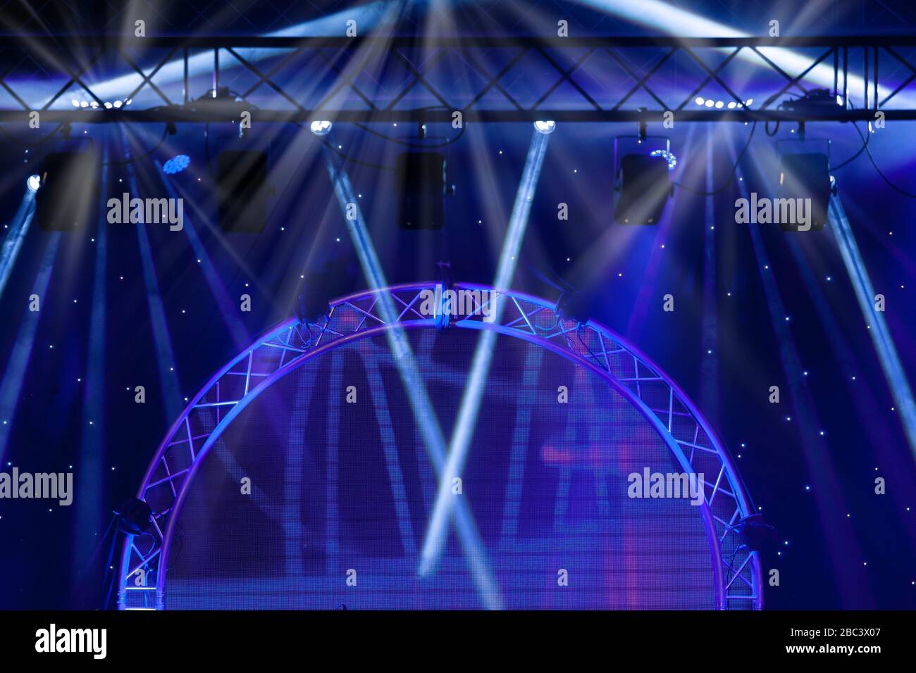 Blue Stage lights and Laser rays with smoky effect background Stock Photo