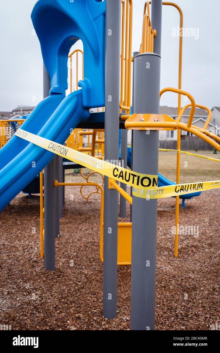 Playground equipment wrapped in caution tape during Covid 19 pandemic. Stock Photo