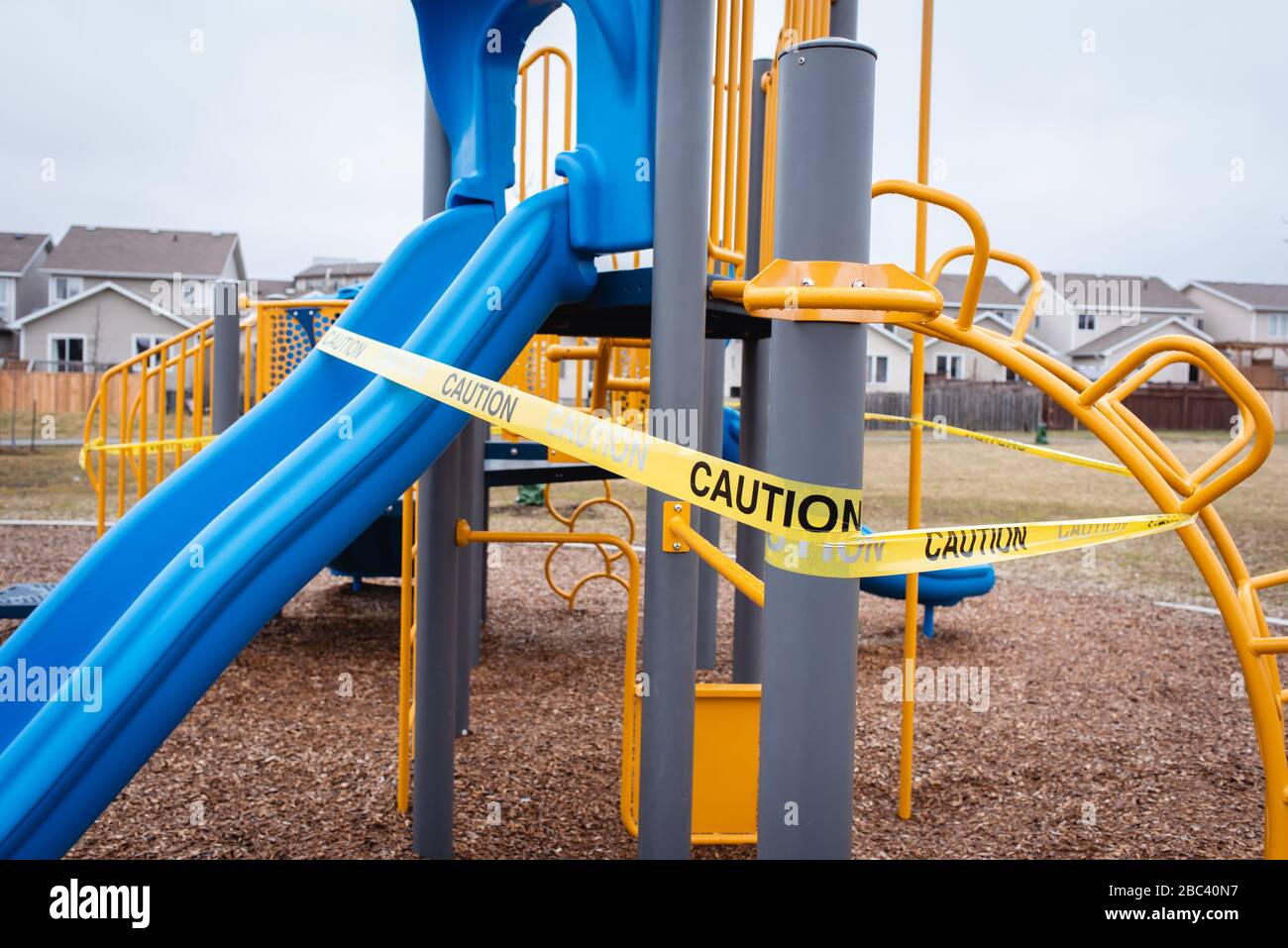 Playground equipment wrapped in caution tape during Covid 19 pandemic. Stock Photo