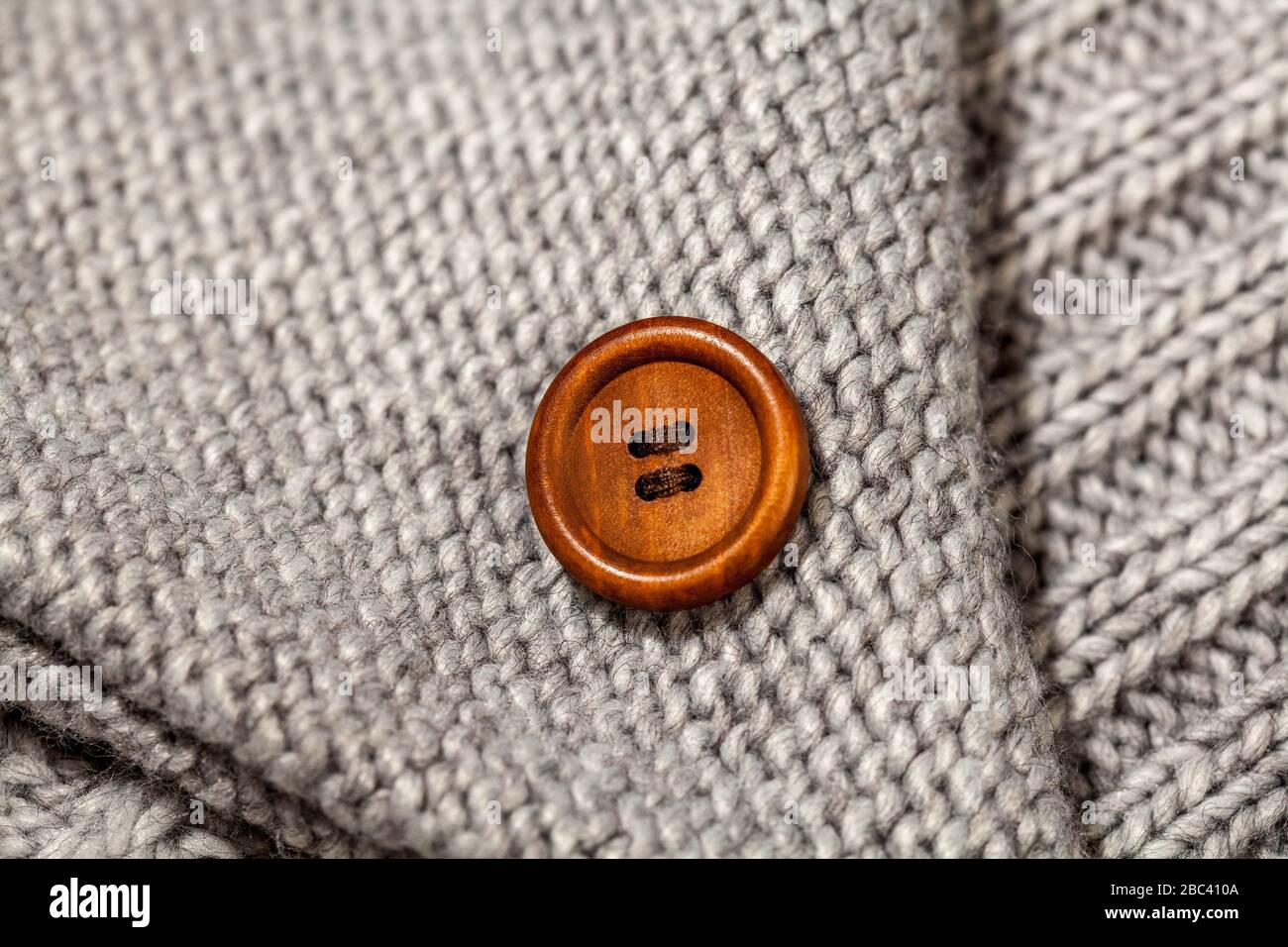 Big vintage brown button on knitted woolen background Stock Photo - Alamy