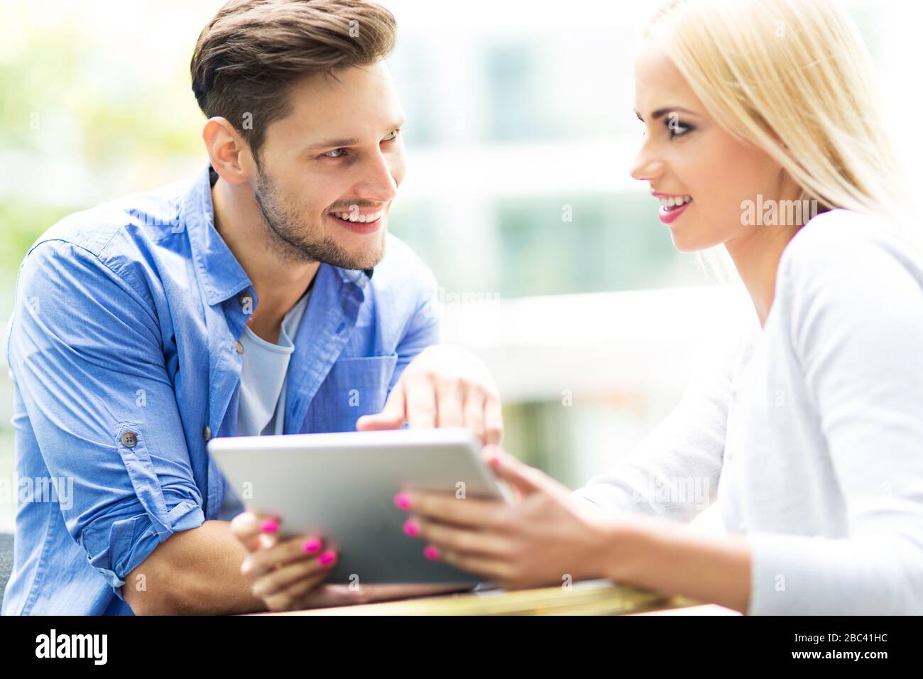 Couple using digital tablet at cafe Stock Photo
