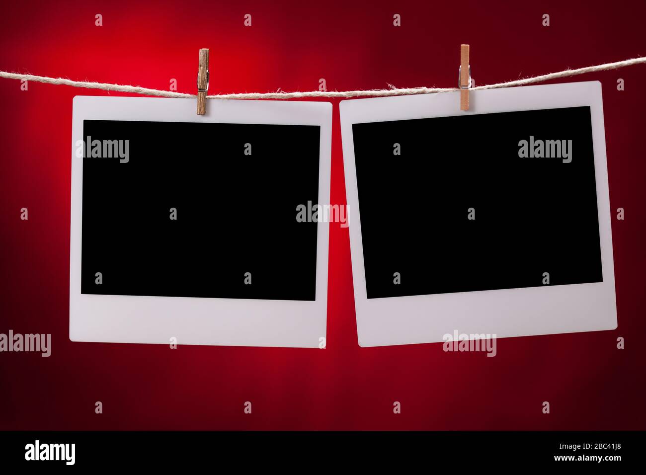 Two blank instant photo frames on red background Stock Photo
