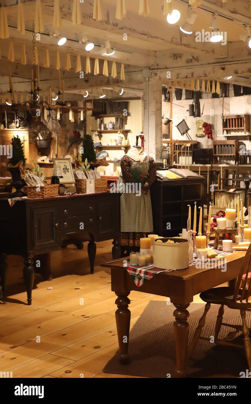 12/21/19 yankee candle store deerfield ma view of old fashioned candle making room with tables and counters showing hanging candles Stock Photo