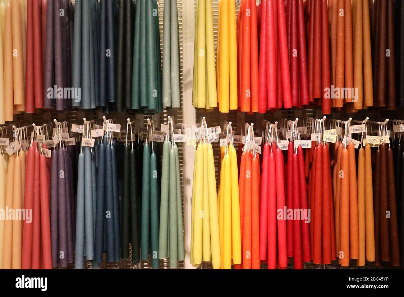 Yankee Candle Deerfield Ma 12/21/19 colorful taper hand dipped candles hanging from slat wall hooks Stock Photo