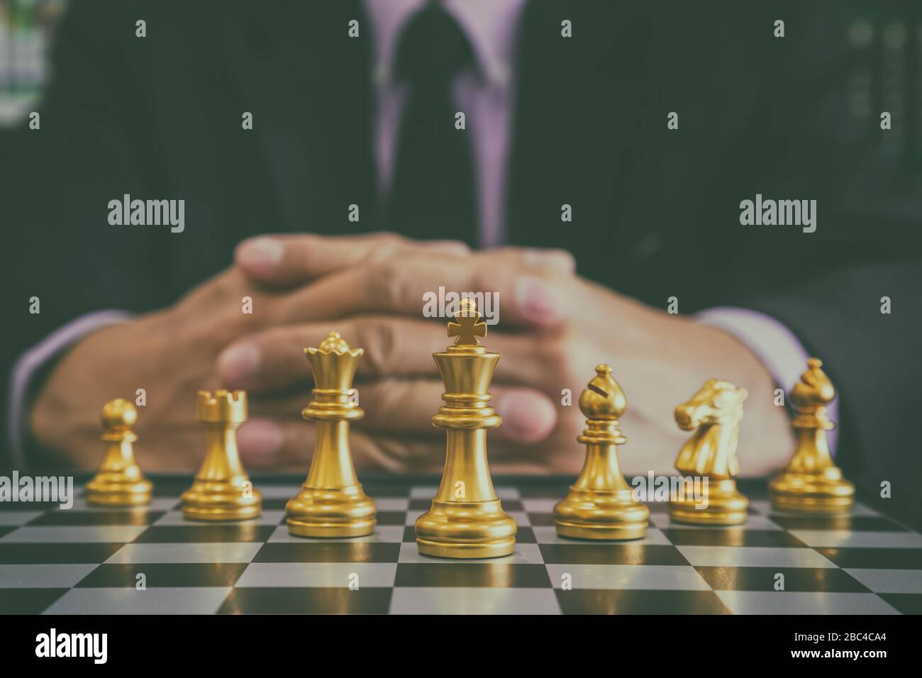 Chess game on chess board behind business man background. Business concept  to present financial information and marketing strategy analysis. Investmen  Stock Photo - Alamy