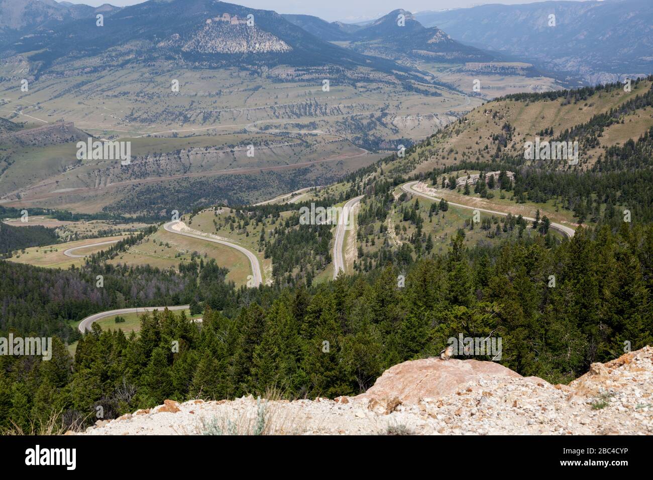 Overlooking the valley and Route 296 as it winds down the mountain as seen from Dead Indian Overlook in Yellowstone National Park, Wyoming. Stock Photo