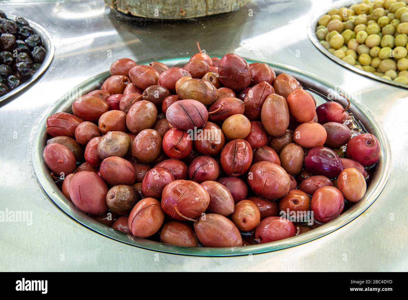 Supermarket olive aisle. Green and black olives in the market Stock