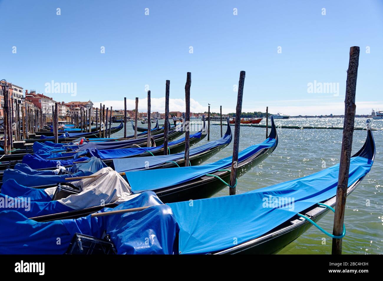 Gondolas on Venice lagoon shoreline Stock Photo - Alamy