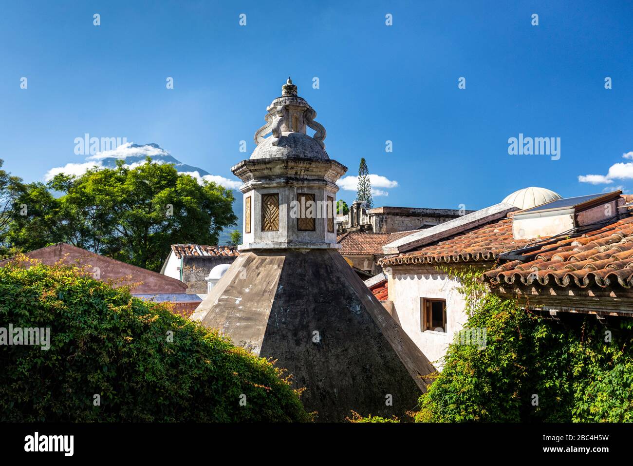 Tiled rooftops and the Agua Volcano in Antiguo, Guatemala. Stock Photo