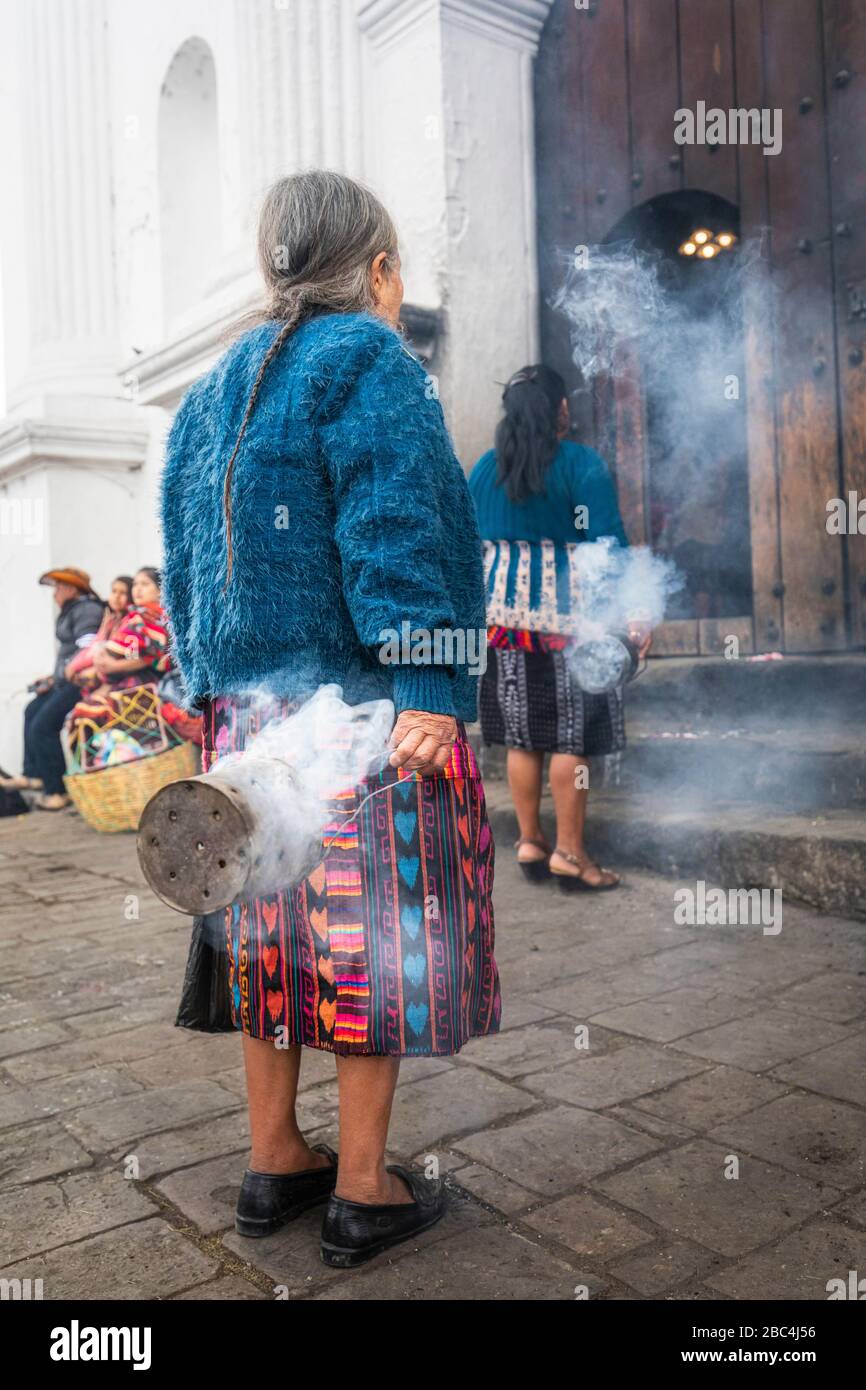 Mayan women swing thuribles outside the St. Thomas church in Chichicastenango, Guatemala. Stock Photo