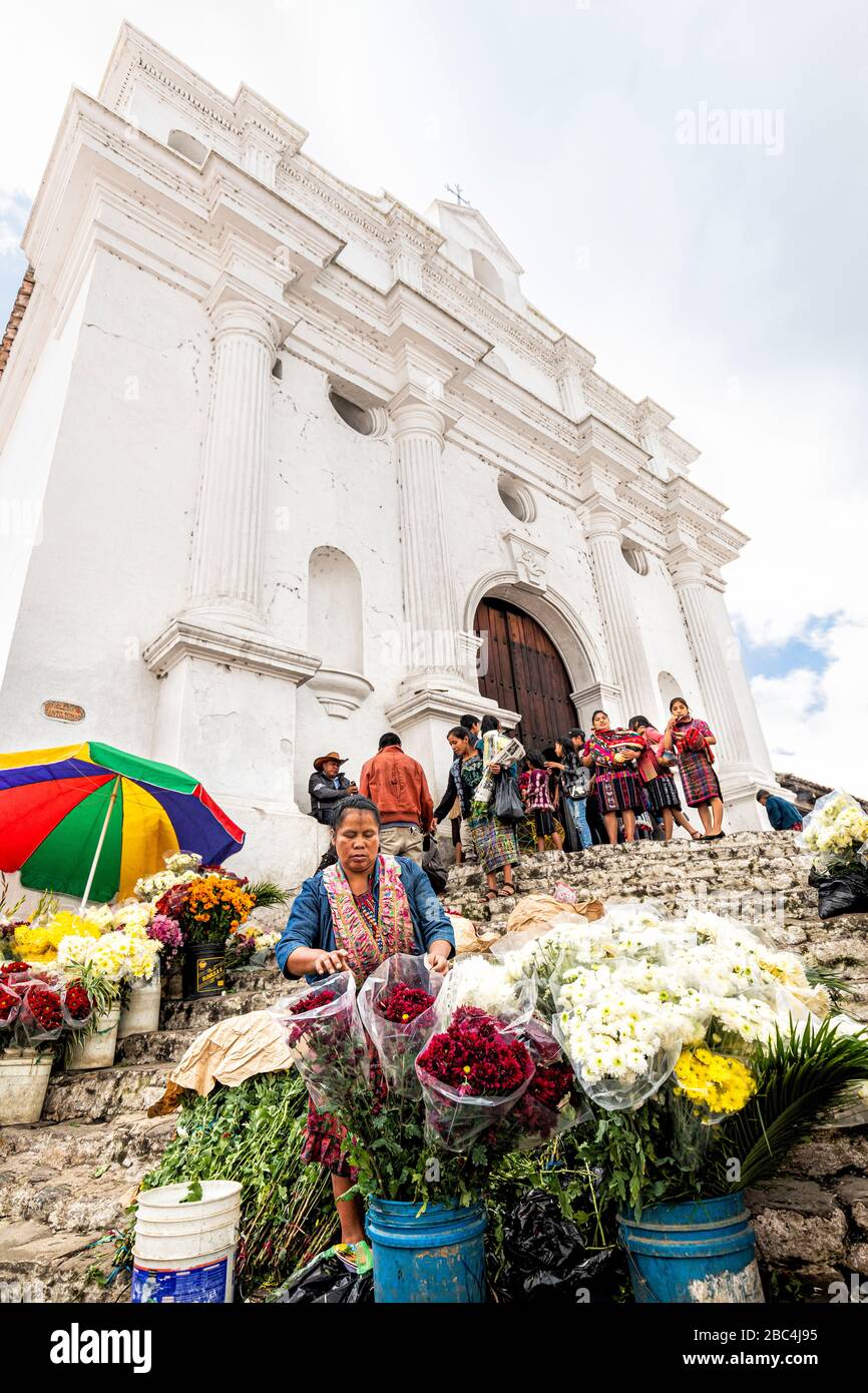 Flower vendor on the steps of the Saint Thomas church in Chichicastenango, Guatemala. Stock Photo
