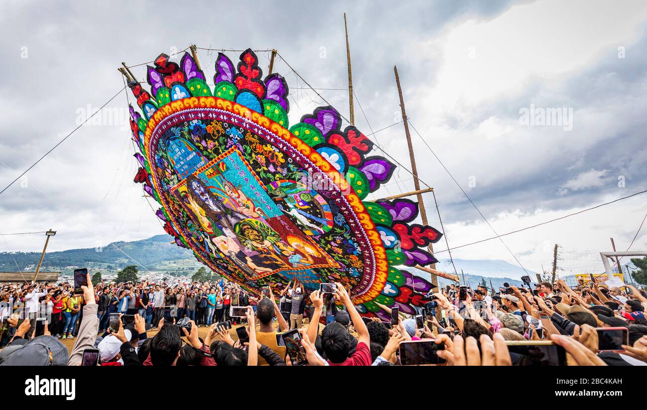 In the midst of the crowd as a large barrilete or kite is raised at the Supango Kite Festival on Day of the Dead, Guatemala. Stock Photo