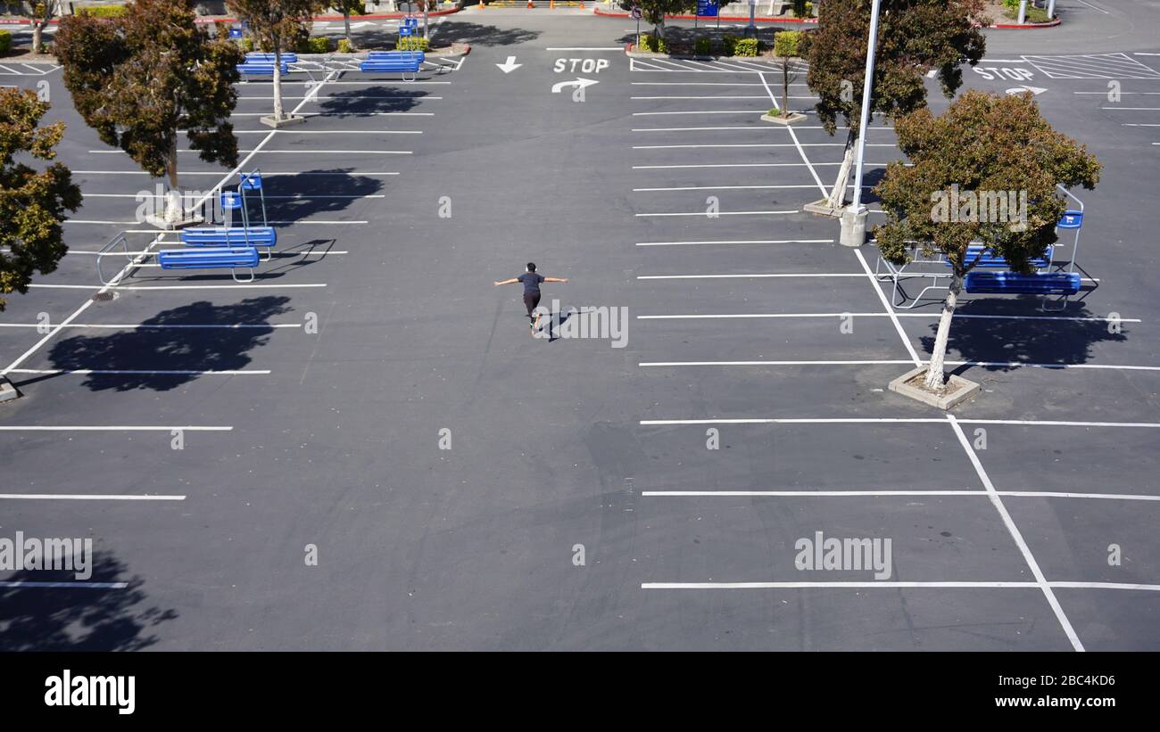 Rollerblader rollerblading in the IKEA parking lot, finding recreation during the COVID19, or coronavirus, lockdown shelter-in-place order. Emeryville Stock Photo