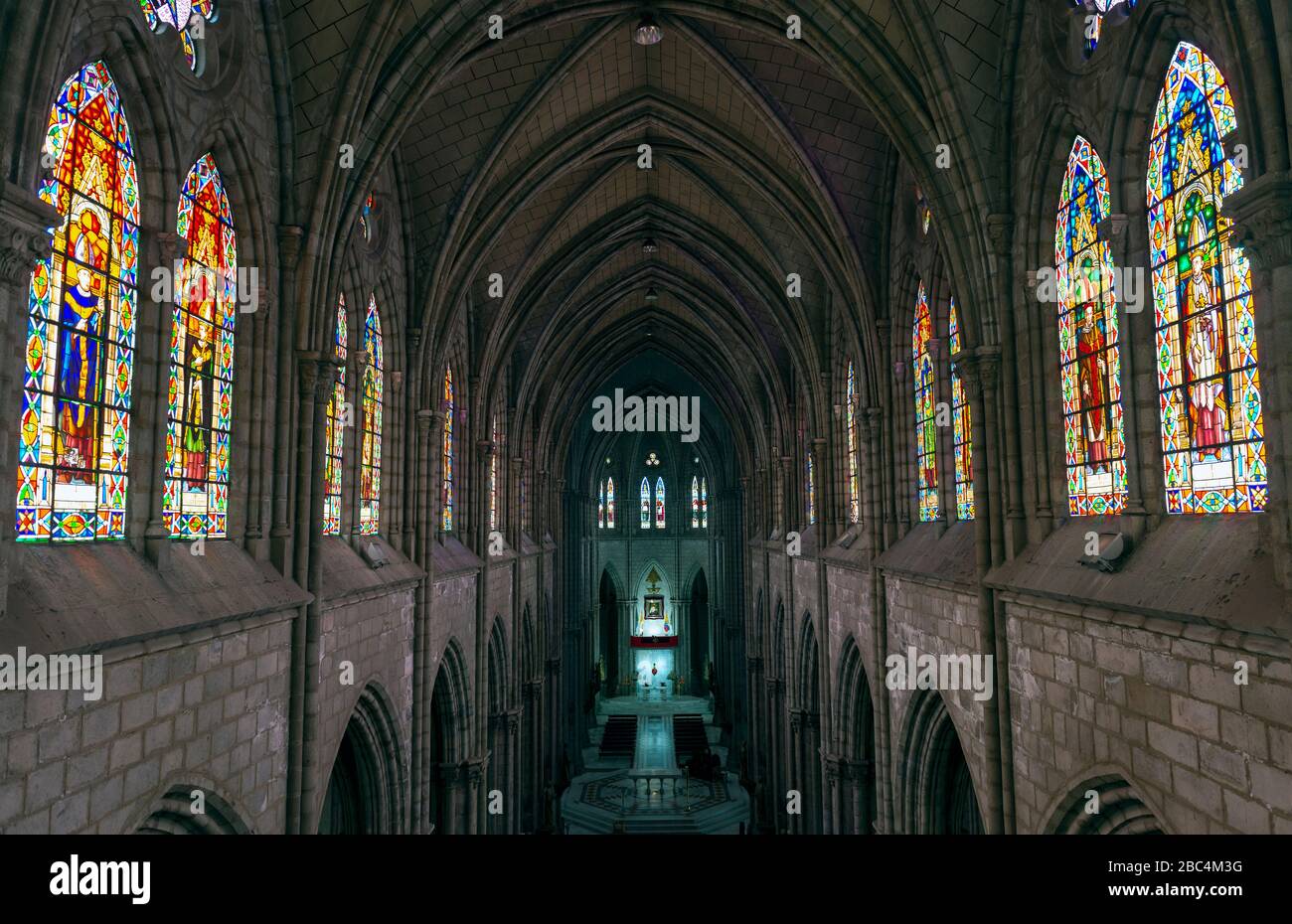 Interior of the Basilica of the National Vow in Neo Gothic style with its colorful stained glass windows, Quito, Ecuador. Stock Photo