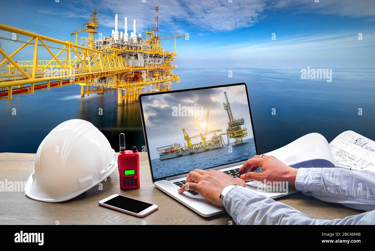 Management operation concept of technicians by using computer control working of offshore crude oil rigs in the Gulf of Thailand, oil and gas explorat Stock Photo