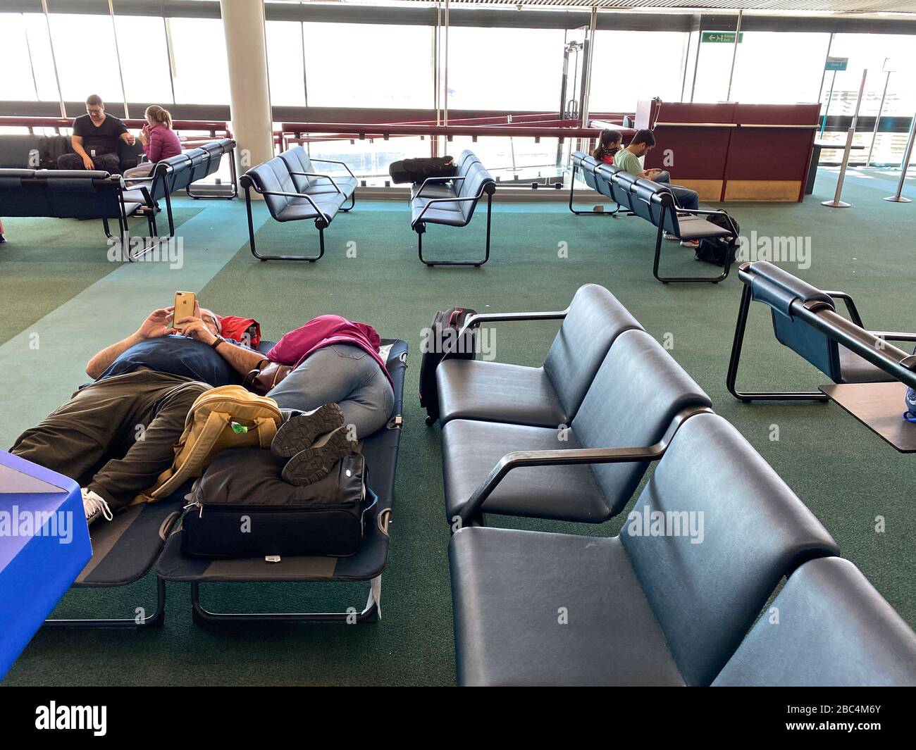 Travelers find themselves trapped at the airport as countries shut down and airlines reduce their flight operations  amid an outbreak of the new corona virus COVID-19. The World Health Organization (WHO) declared COVID-19 a pandemic, globally widespread on March 11. Stock Photo