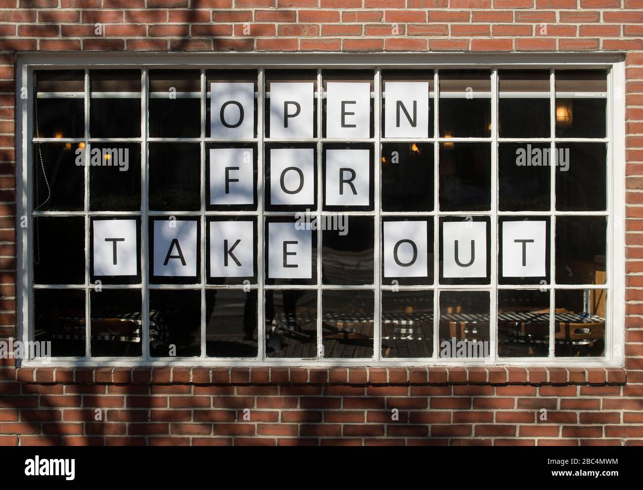 Lexington, MA, USA.  26 Mar. 2020.  Front window of 45 year-old Italian restaurant in central Lexington has been forced to serve takeout only due to the Coronavirus (COVID-19) pandemic. Stock Photo