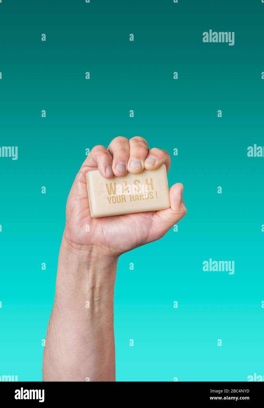 Caucasian male hand holding bar of soap with message "Wash Your Hands