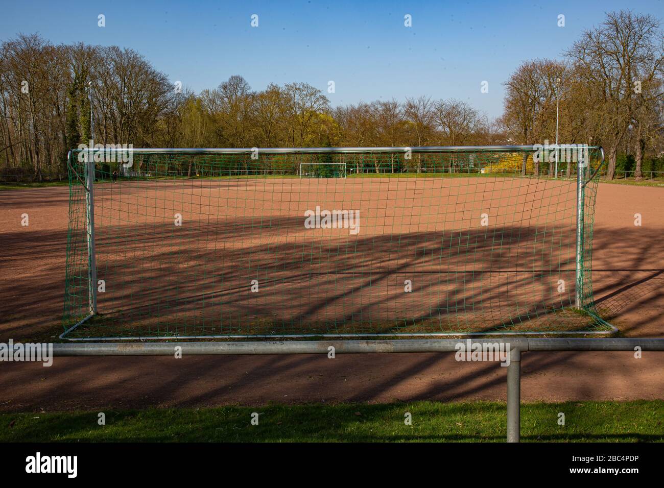 empty football ground in the sun based on championship interruption because of corona Stock Photo