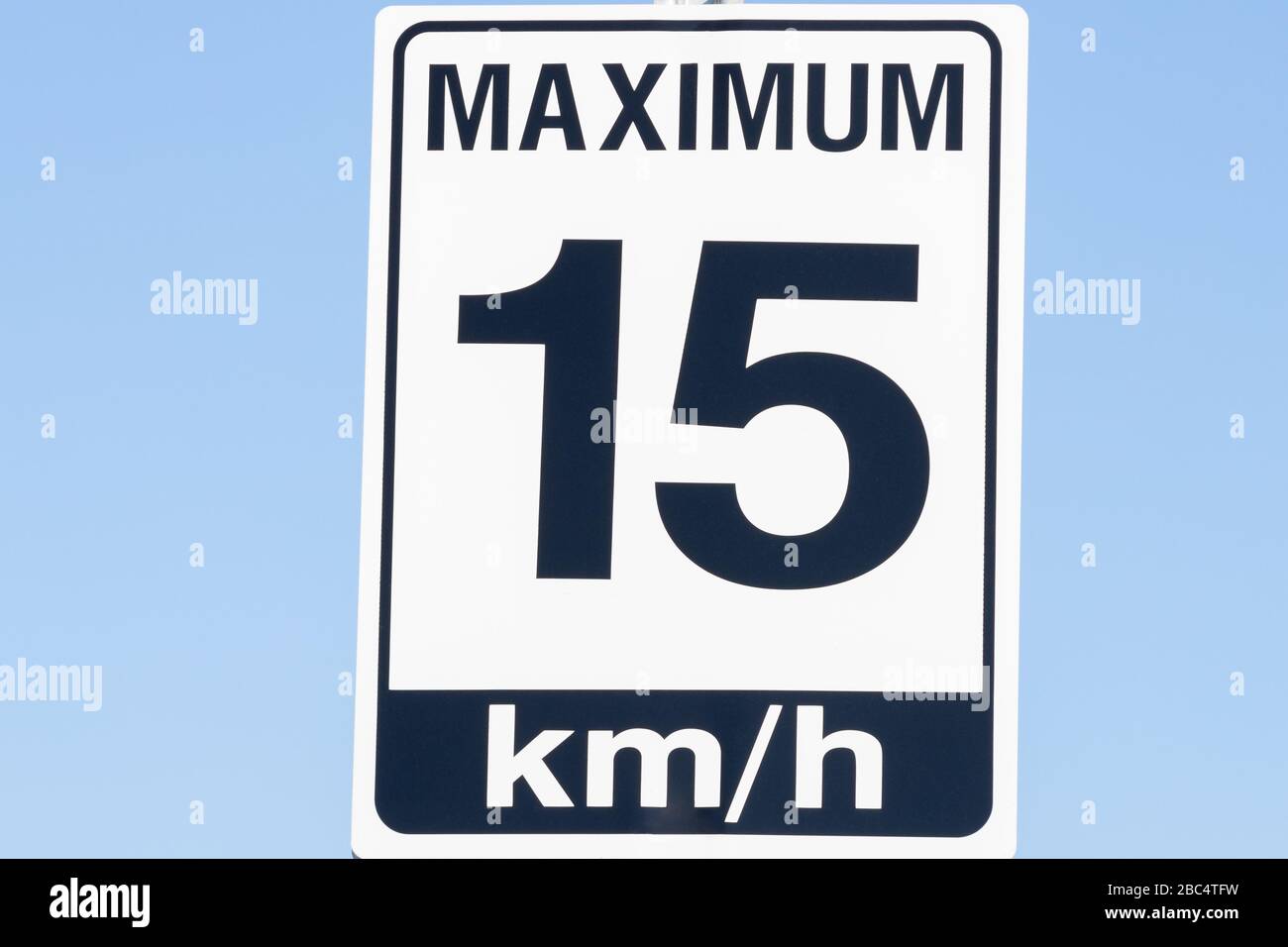 15 KM/H speed warning sign, close up view with blue sky background. Stock Photo