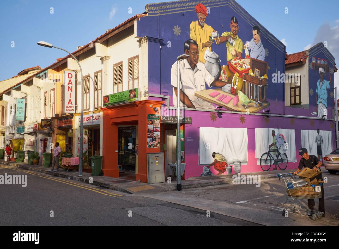 A wall painting in Belilios Lane, Little India, Singapore, depicts early Indian immigrants in some of their typical professions Stock Photo