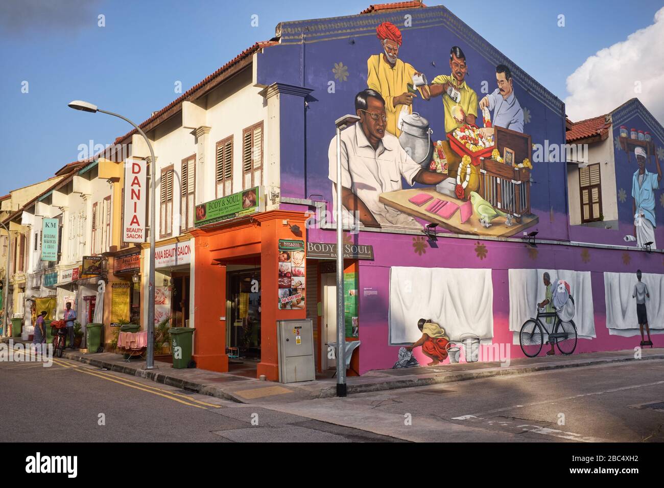 A wall painting in Belilios Lane, Little India, Singapore, depicts early Indian immigrants in some of their typical professions Stock Photo