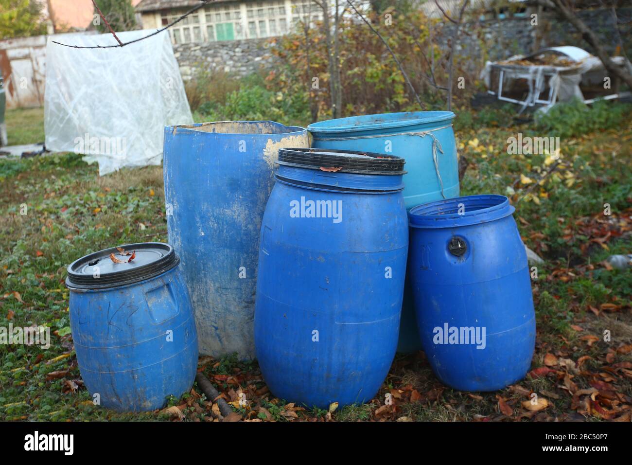The blue plastic barrels for storage of chemicals . Stockpile of used