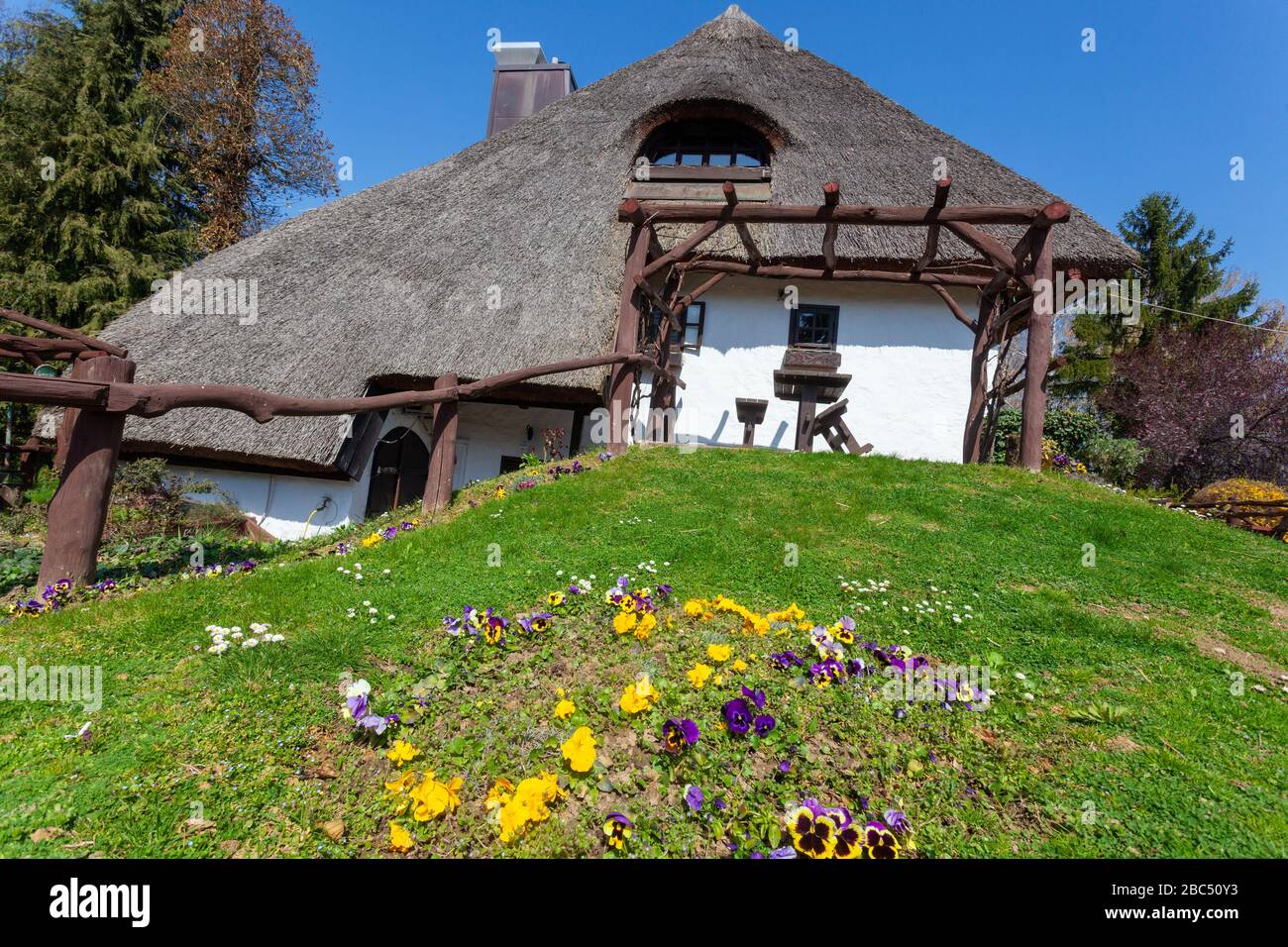 Traditional rural house with a thatched roof in Podravina region of Croatia (PRC) - Restaurant Podravska klet on PRC Stock Photo