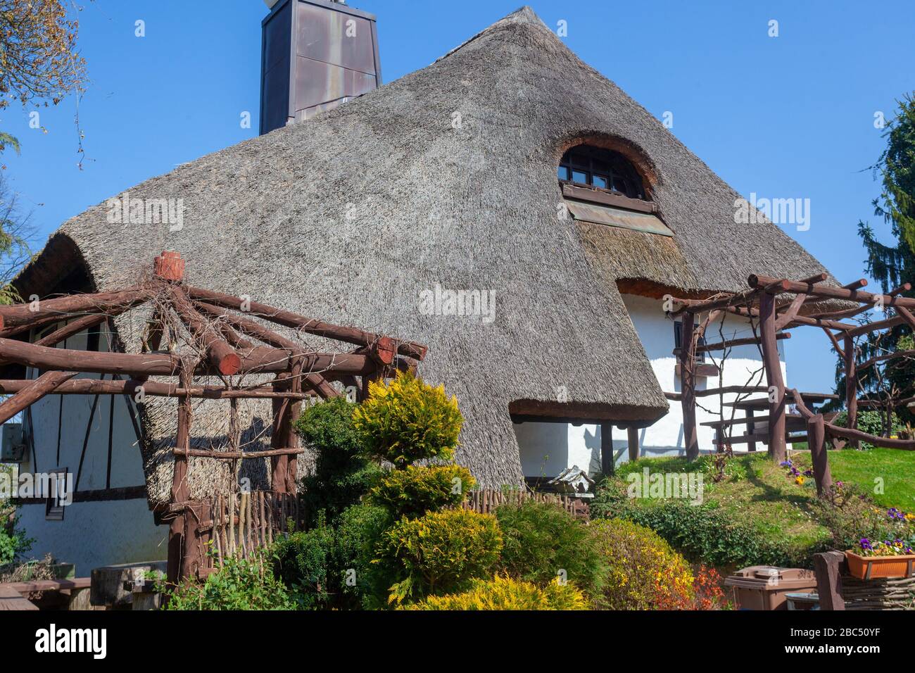 Traditional rural house with a thatched roof in Podravina region of Croatia (PRC) - Restaurant Podravska klet on PRC Stock Photo
