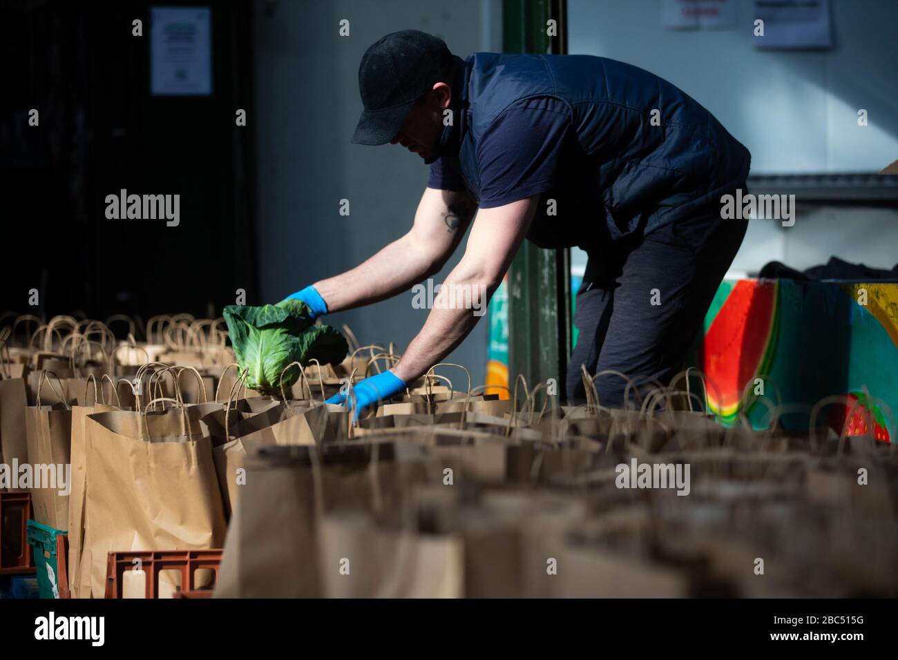 EDITORIAL USE ONLY Volunteers prepare some of the thousand fruit and vegetable packages destined for healthcare workers fighting the COVID-19 pandemic as Borough Market spearheads the national ‘Feed The Frontline’ campaign, London. Stock Photo