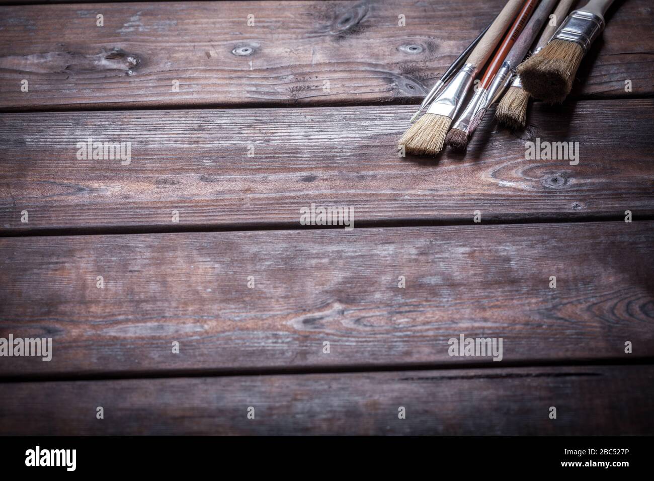 Close-up of Artist paint brushes over natural wooden background Stock Photo