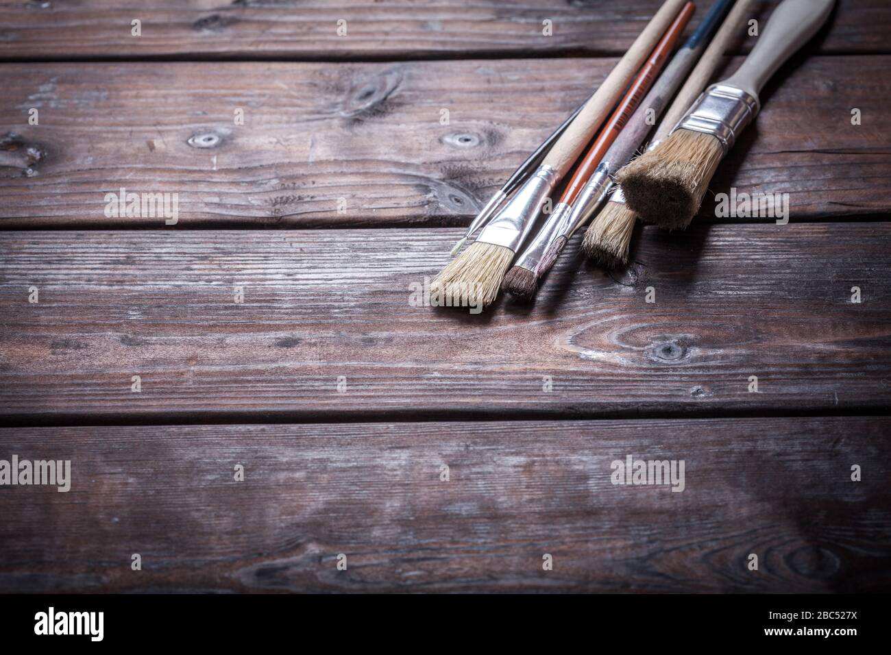 Close-up of Artist paint brushes over natural wooden background Stock Photo