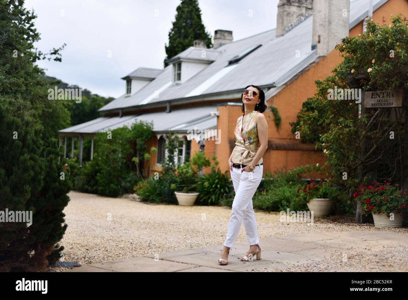 Woman traveller at a historic country house and hotel Mittagong, Southern Highlands New South Wales, Australia Stock Photo