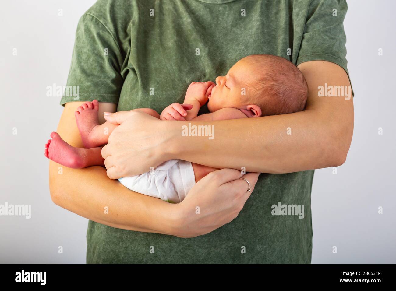 Beautiful new born baby resting on mom's hands Stock Photo Alamy