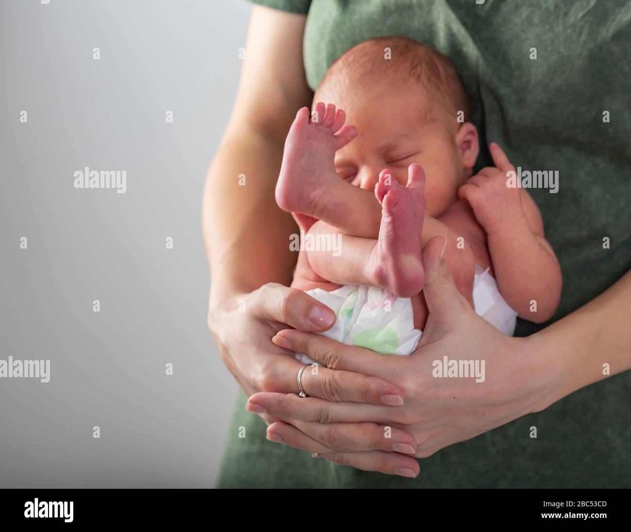Beautiful new born baby resting on mom's hands Stock Photo Alamy