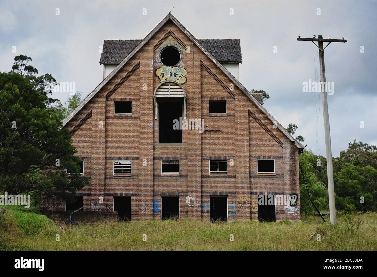 North east facing end view of the derelict A line brick industrial building Malt House 3, Mittagong NSW Stock Photo