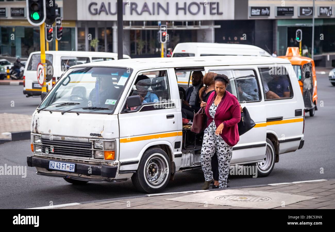 Johannesburg, South Africa 18th February - 2020: Commuter getting out of minibus taxi. Stock Photo