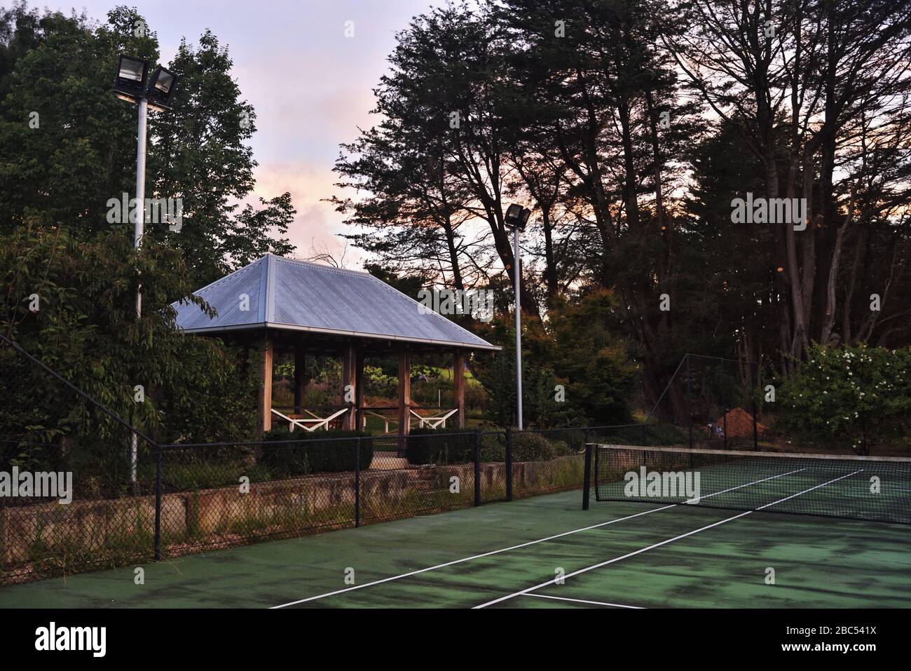 Old tennis court in a country house garden, late afternoon Mittagong, Southern Highlands, Australia Stock Photo