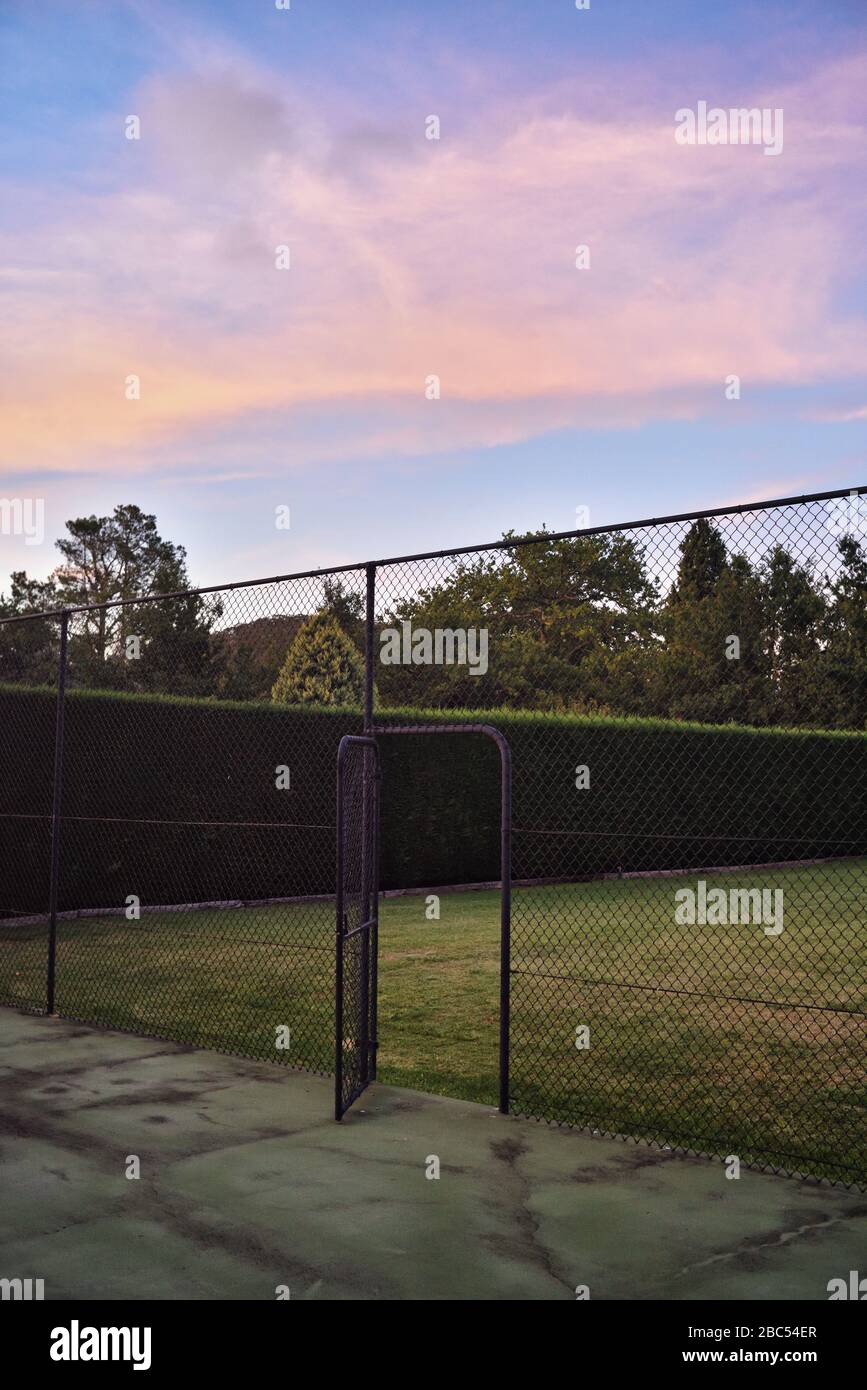 Old tennis court in a country house garden, late afternoon Mittagong, Southern Highlands, Australia Stock Photo