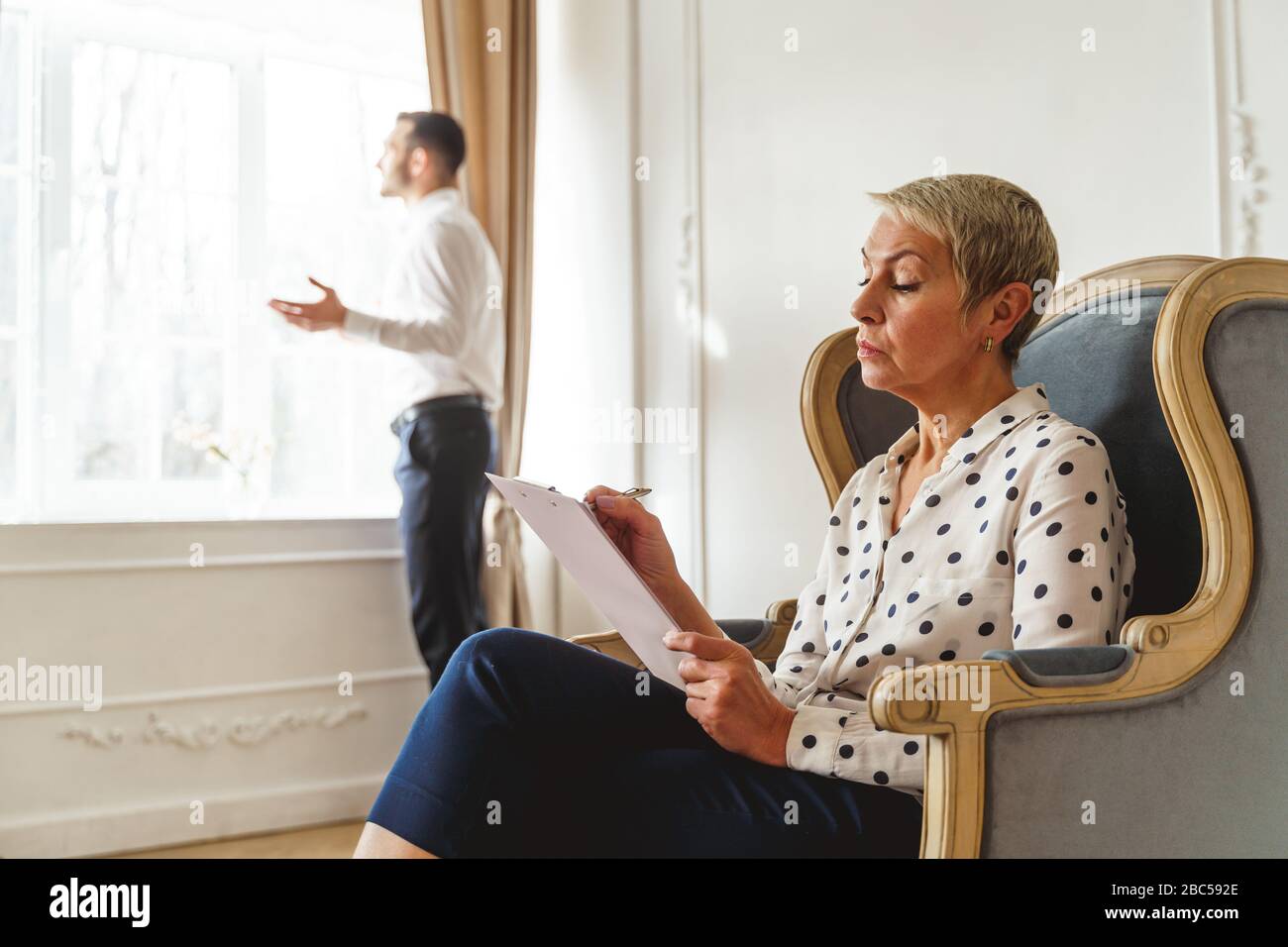 Psychoanalyst jotting down notes during the therapy session Stock Photo