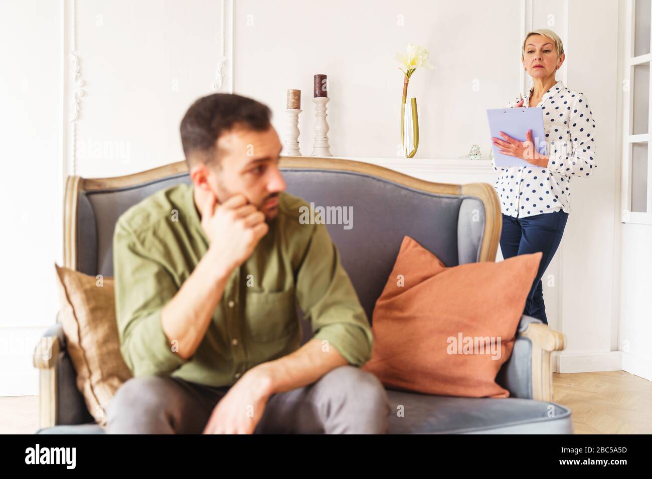 Low-spirited short-haired modern young man looking away Stock Photo