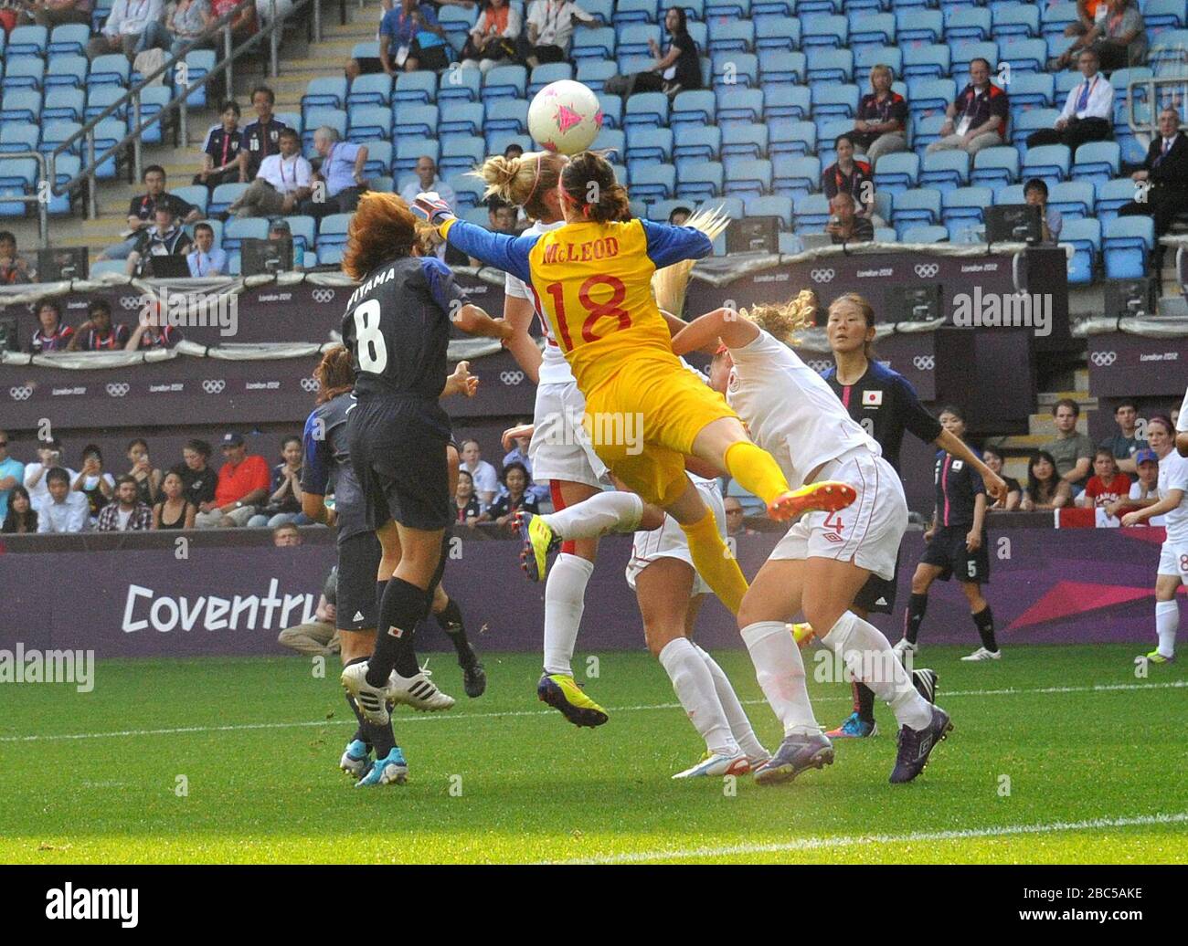 Japan's Aya Miyama heads past Canada's Erin McLeod to score their