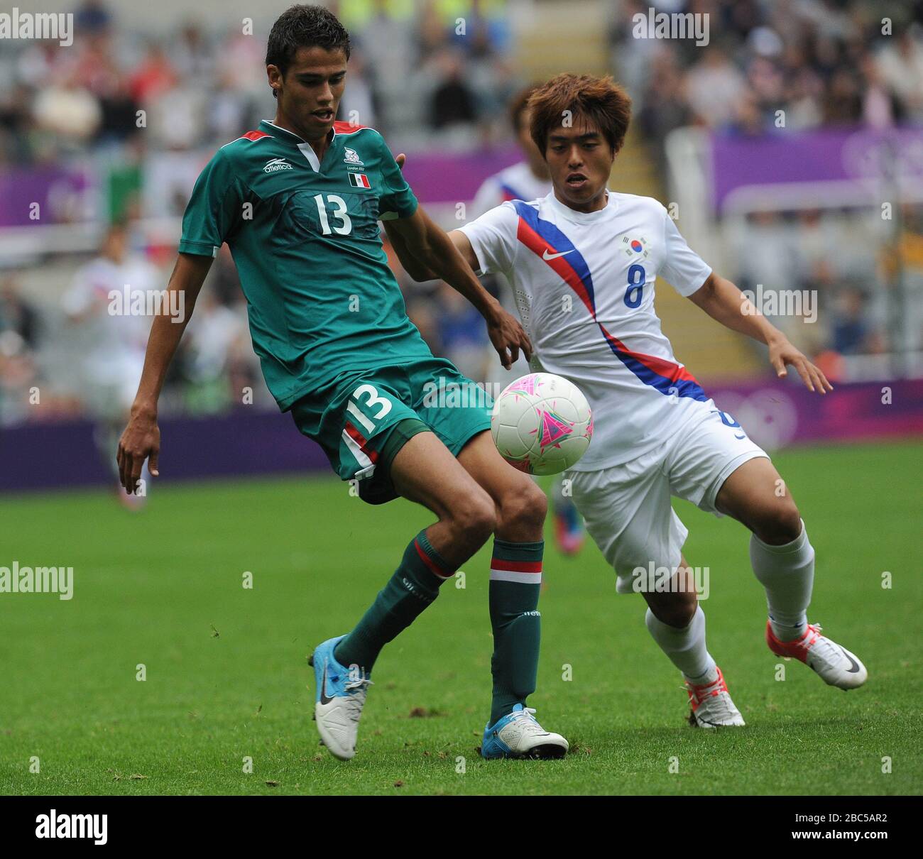 Mexico's Diego Reyes (left) and South Korea's Baek Sungdong during the Mexico v South Korea, Mens Football, First Round, Group B match at St James' Park, Newcastle. Stock Photo
