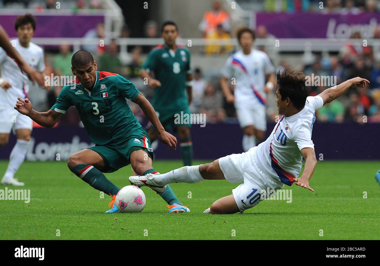 Mexico's Carlos Salcido (left) is tackled by South Korea's Park Chu-Young during the Mexico v South Korea, Mens Football, First Round, Group B match at St James' Park, Newcastle. Stock Photo