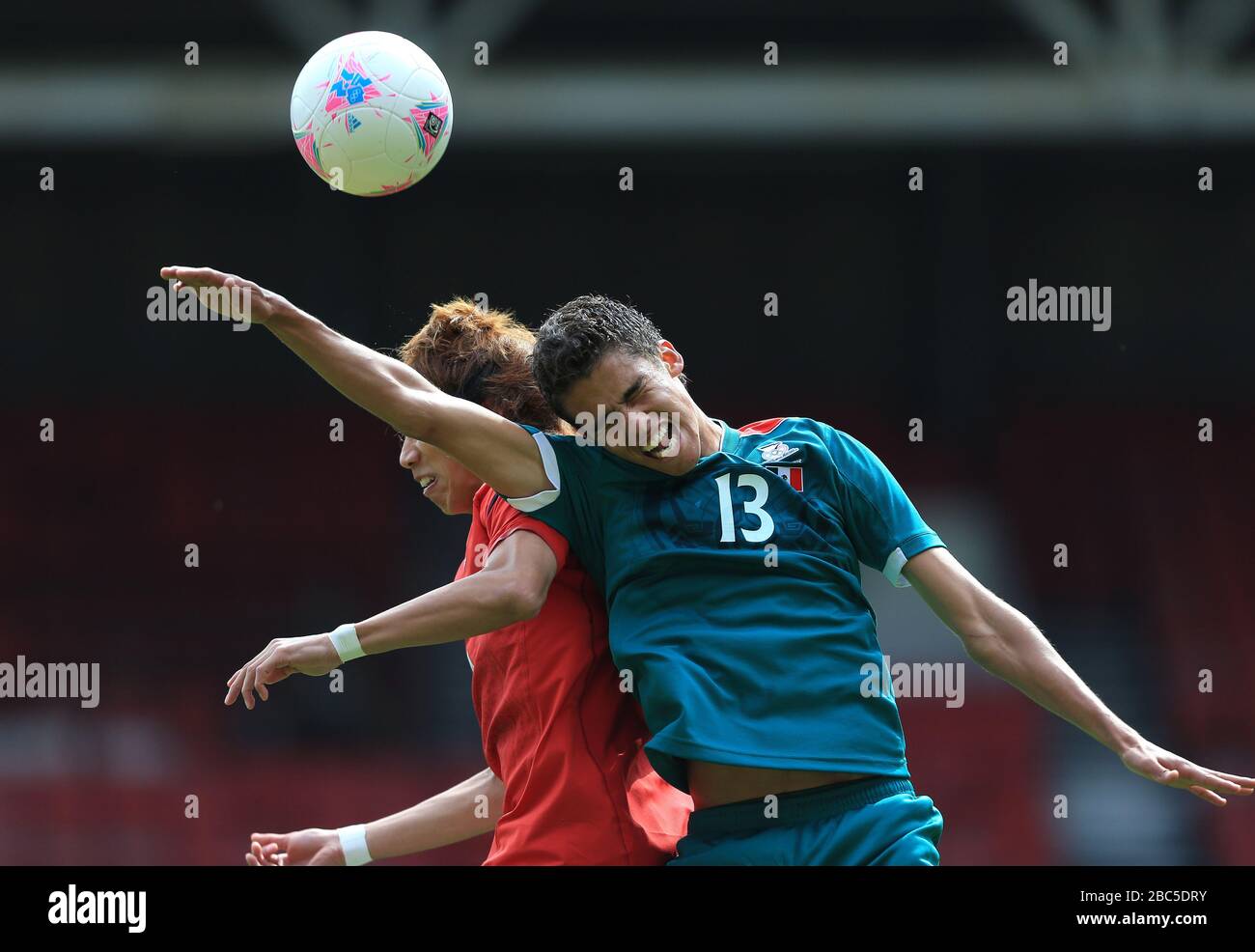 Japan's Yuki Otsu and Mexico's Diego Reyes battle for the ball Stock Photo