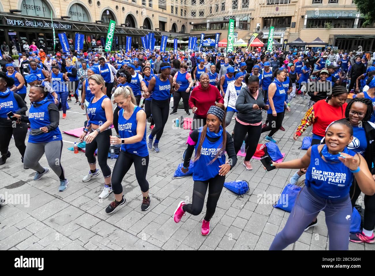 Johannesburg, South Africa, 29th February - 2020: Outdoor fitness class. People enjoying exercise class in public space. Stock Photo