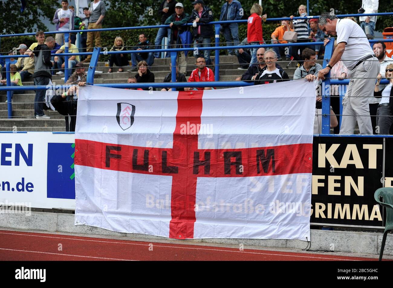 Fulham fans in the stands at the game in Grimma, Germany. Stock Photo
