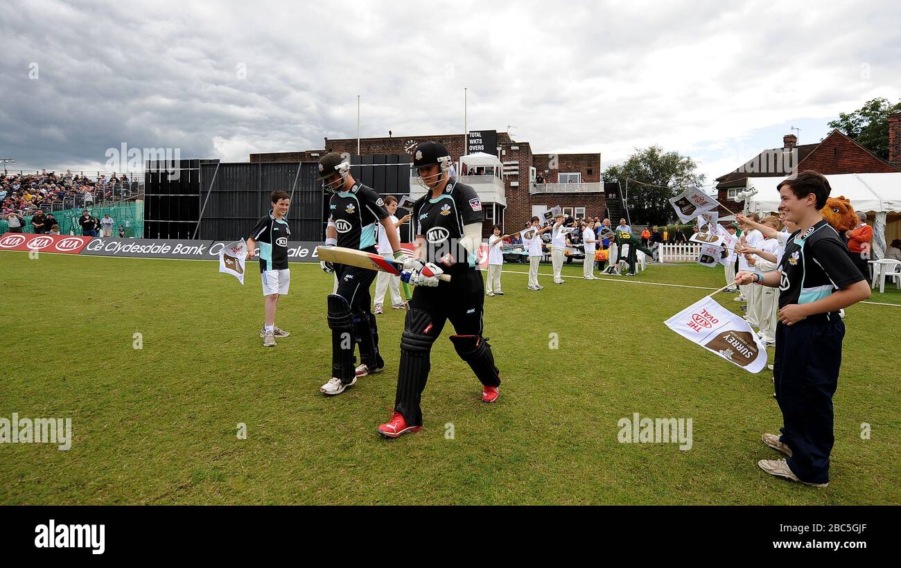 Surrey Lions' Steven Davies (left) and Jason Roy (right) walk out to bat against the Nottinghamshire Outlaws' at Guildford. Stock Photo