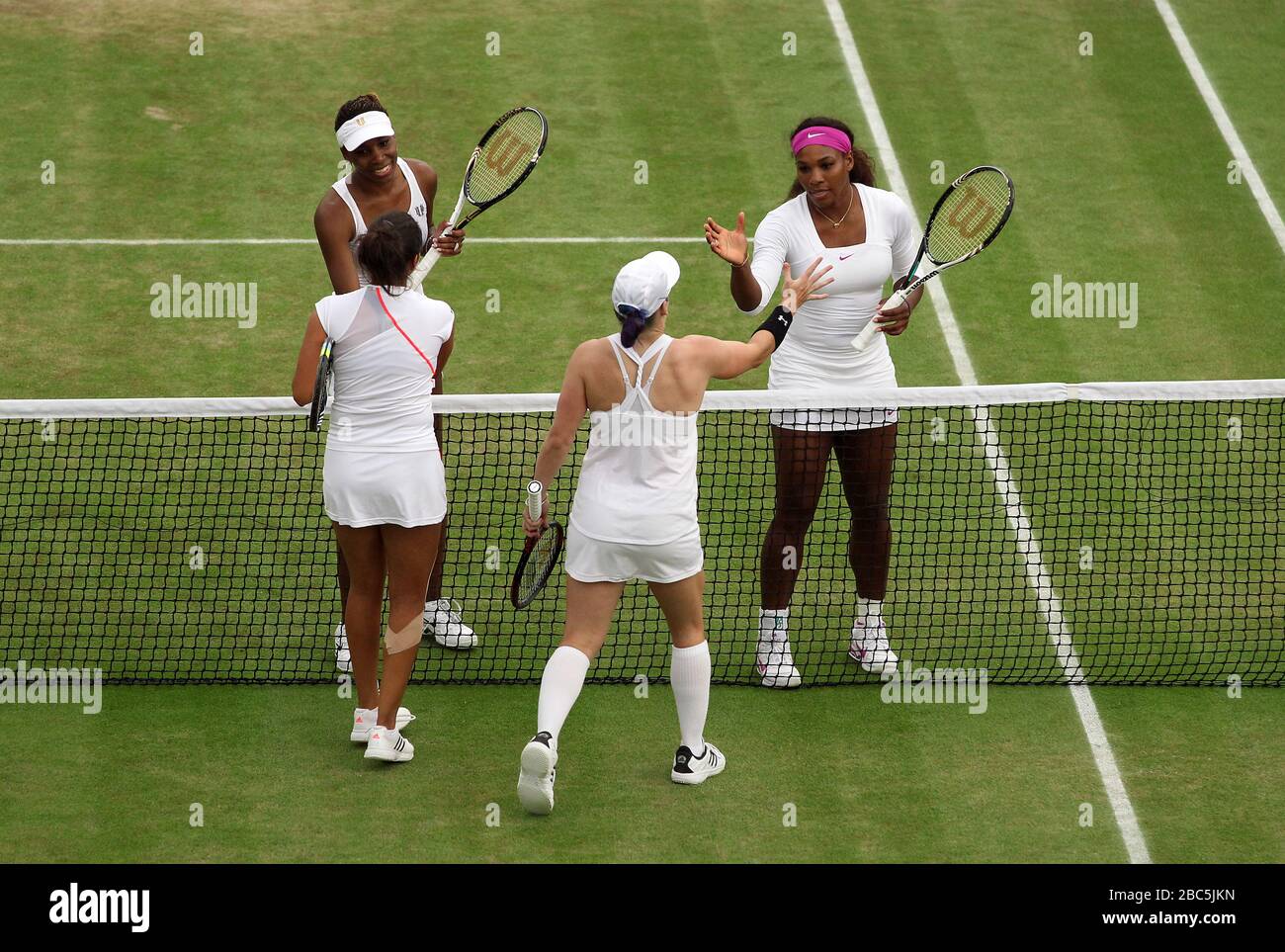 USA's Serena and Venus Williams shake hands with their opponents USA's Bethanie Mattek-Sands and India's Sania Mirza after beating them in their doubles match Stock Photo