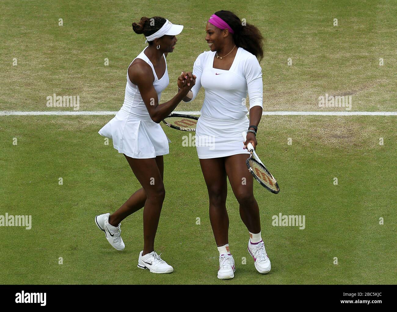 The USA's Venus (left) and Serena Williams celebrate their win over the USA's Liezel Huber and Lisa Raymond in the womens doubles Stock Photo